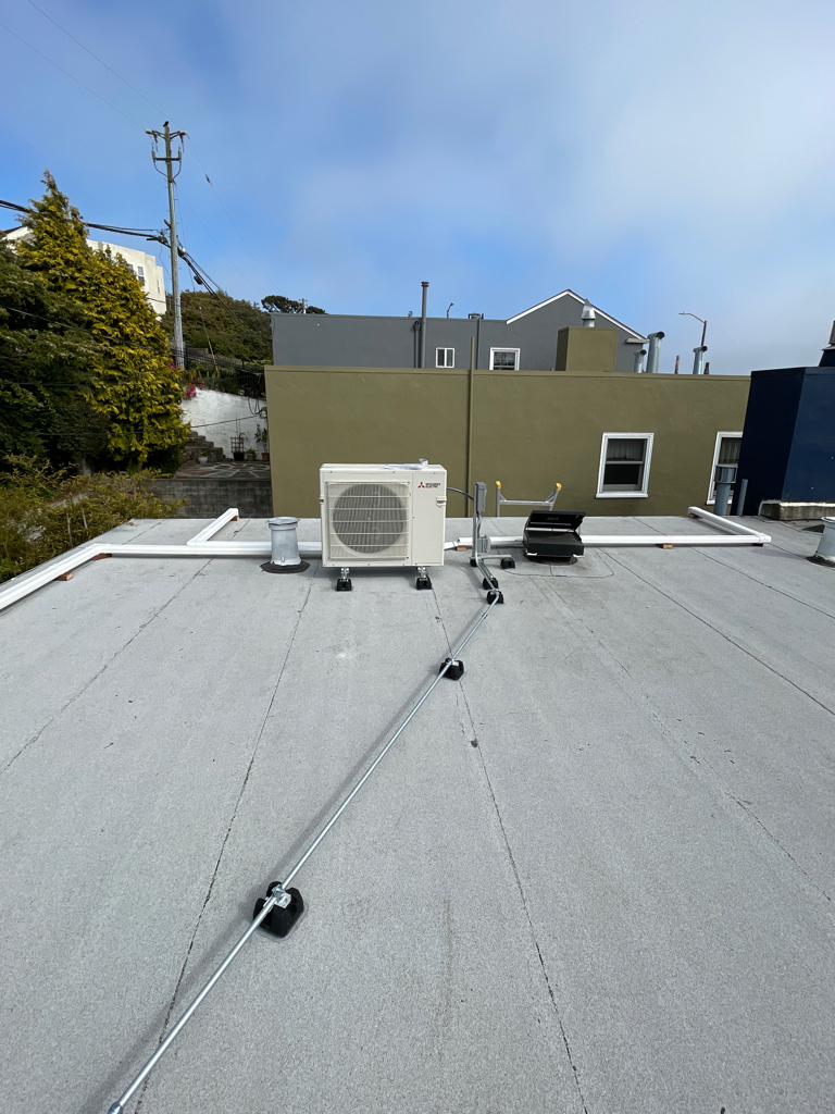 Mitsubishi multi-zone heat pump outdoor unit installed on a San Francisco rooftop